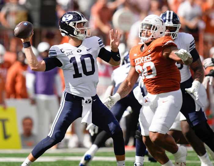 BYU Cougars quarterback Kedon Slovis throws under press ure from Texas Longhorns defensive lineman Byron Murphy II in the first quarter at Royal-Memorial Stadium on Saturday October 28, 2023.  